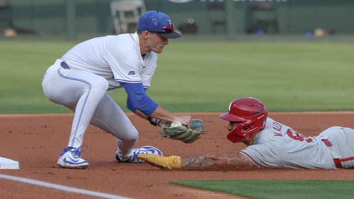 Arkansas Razorbacks shortstop Wehiwa Aloy comes up short on a slide into third base against the Creighton Bluejays in the NCAA Regional Arkansas Razorbacks shortstop Wehiwa Aloy comes up short on a slide into third base against the Creighton Bluejays in the NCAA Regional