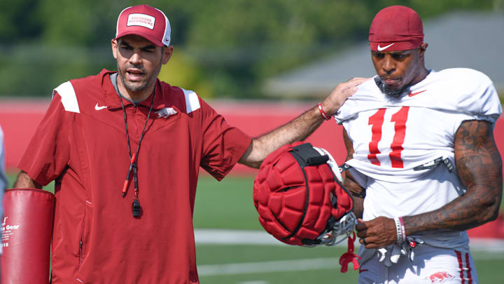 Arkansas Razorbacks wide receivers coach Ronnie Fouch with Monte Harrison during a break between drills on the outdoor turf field practice field in Fayetteville, Ark. Arkansas Razorbacks wide receivers coach Ronnie Fouch with Monte Harrison during a break between drills on the outdoor turf field practice field in Fayetteville, Ark.