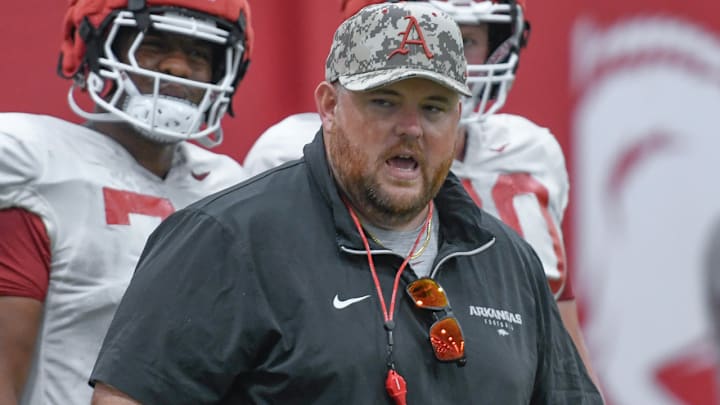 Arkansas Razorbacks offensive line coach Eric Mateos directing drills during Thursday morning's media viewing section of practice on the indoor field.