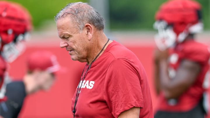 Arkansas Razorbacks coach Sam Pittman walking the outdoor practice field during preseason drills in Fayetteville, Ark.