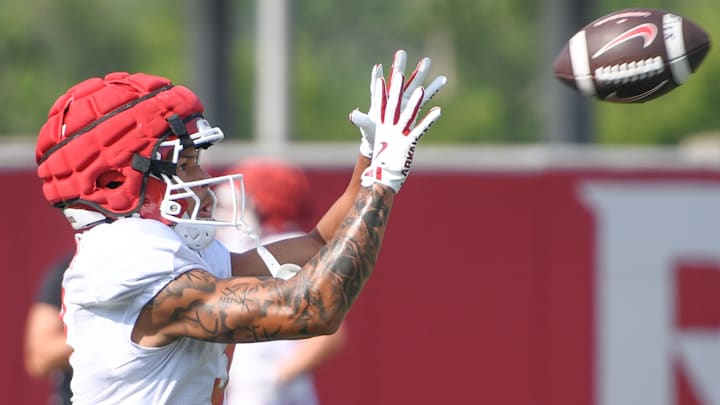 Arkansas Razorbacks wide receiver CJ Brown goes up for a catch in preseason practices on the outdoor fields in Fayetteville, Ark.