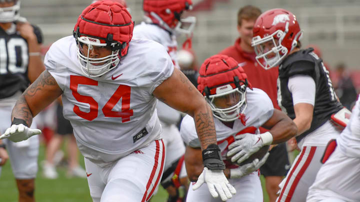 Arkansas Razorbacks' Keyshawn Blackstock secures block during spring practice. Coach Sam Pittman announced the redshirt senior will move to defensive tackle for the 2025 season. 