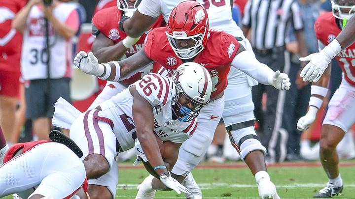 Arkansas Razorbacks defensive lineman Quincy Rhodes makes a tackle Alabama A&M Bulldogs running back Ryan Morrow in game at Razorback Stadium in Fayetteville, Ark. Arkansas Razorbacks defensive lineman Quincy Rhodes makes a tackle Alabama A&M Bulldogs running back Ryan Morrow in game at Razorback Stadium in Fayetteville, Ark.