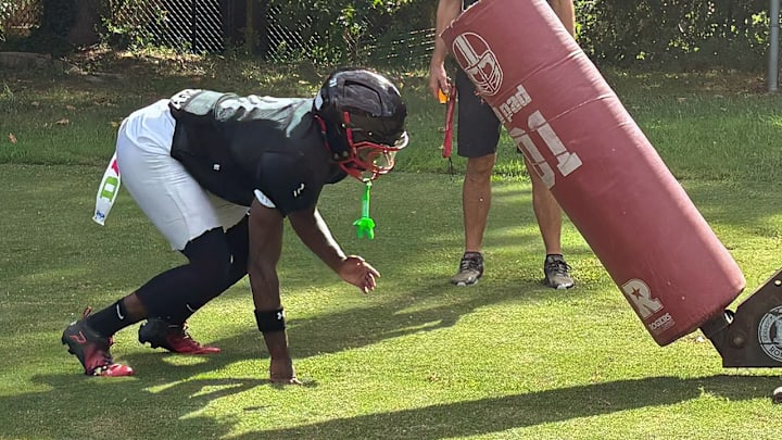 A Quince Orchard offensive lineman prepares to hit a blocking sled during preparations for the 2025 football season. A Quince Orchard offensive lineman prepares to hit a blocking sled during preparations for the 2025 football season.