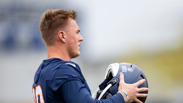 Denver Broncos rookie quarterback Bo Nix dons his helmet at rookie minicamp.