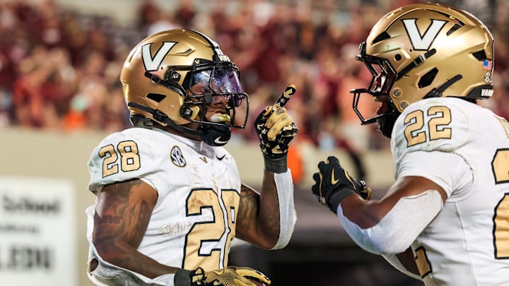 Sedrick Alexander (28) and MK Young (22) celebrate a touchdown at Virginia Tech.