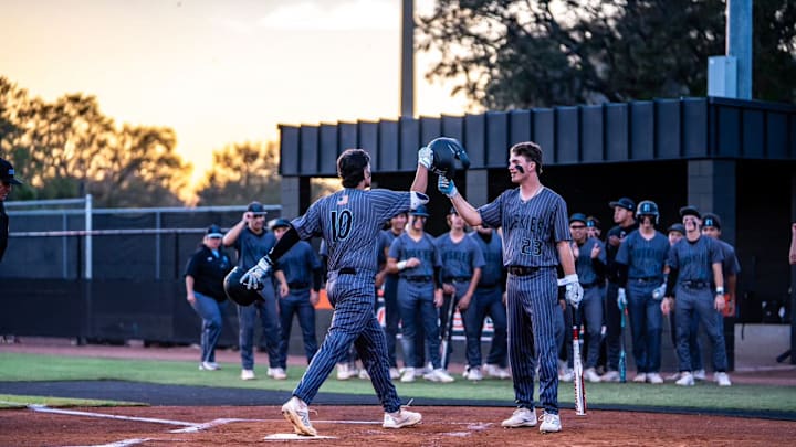 Hagerty's Ryan Foscolo, right, congratulates teammate Max Murray Jr. as he crosses the plate in a recent game. Last week, Fuscolo went 3-for-4 with two runs scored and one RBI to guide the Huskies past Beachside, 14-4, in the 42 Challenge Tournament.