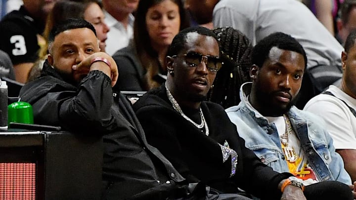 Jan 2, 2020; Miami, Florida, USA; Recording artists DJ Khaled (R) sits with Sean  Diddy  Combs (C) and Meek Mill (L) during the first half between the Miami Heat and the Toronto Raptors at American Airlines Arena. Mandatory Credit: Jasen Vinlove-Imagn Images