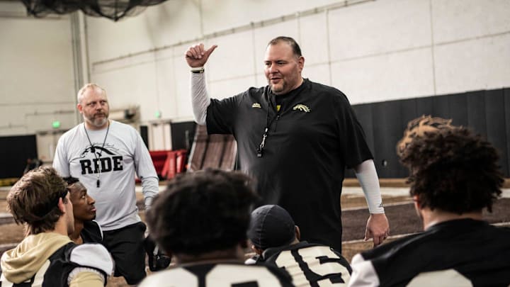 Western Michigan defensive coordination/defensive line coach Lou Esposito speaks with defensemen on