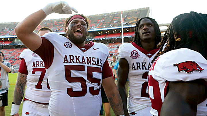 Arkansas Razorbacks offensive lineman Fernando Carmona (55) celebrates with fans after the Razorbacks beat the Auburn Tigers at Jordan-Hare Stadium.