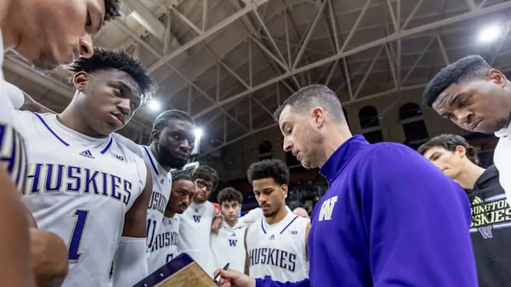 Great Osobor (1) and his UW teammates listen to Danny Sprinkle during a timeout.