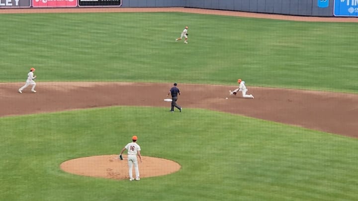 Manny Lebron of Padua makes a sliding defensive play during the 2024 OHSAA Division II state semifinals against Badin as pitcher Nathan Krayzel looks on. 