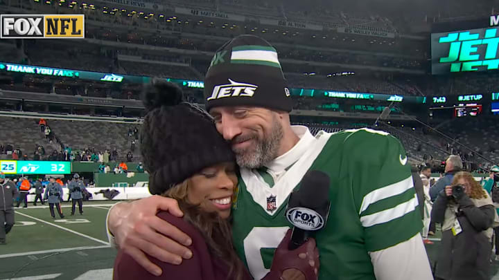 Aaron Rodgers and Pam Oliver share a warm hug after the Jets beat the Dolphins.