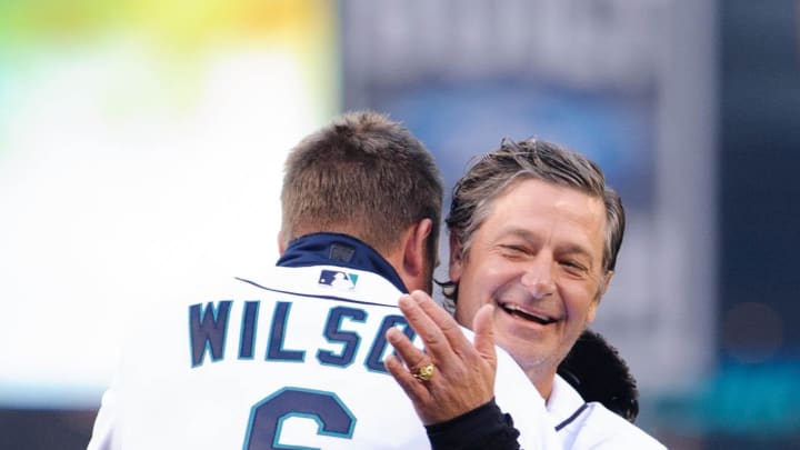 Former Seattle Mariners pitcher Jaime Moyer hugs former Seattle Mariners catcher Dan Wilson prior to the game between the Seattle Mariners and the Houston Astros at Safeco Field in 2013.
