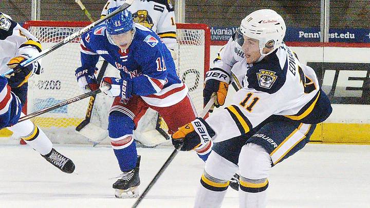 Erie Otters forward Dylan Edwards, right, competes against the Kitchener Rangers in the first period of the Otters home opener at Erie Insurance Arena in Erie on Sept. 20, 2025.