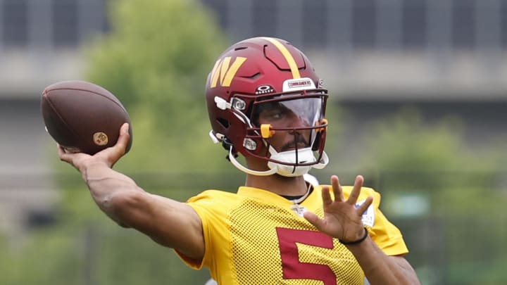 Jun 5, 2024; Ashburn, VA, USA; Washington Commanders quarterback Jayden Daniels (5) prepares to pass a ball during an OTA workout at Commanders Park. Mandatory Credit: Geoff Burke-USA TODAY Sports