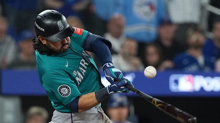 Oct 19, 2025; Toronto, Ontario, CAN; Seattle Mariners third baseman Eugenio Suarez (28) hits a RBI single in the sixth inning against the Toronto Blue Jays during game six of the ALCS round for the 2025 MLB playoffs at Rogers Centre. Mandatory Credit: Nick Turchiaro-Imagn Images