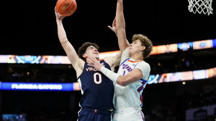 Blake Buchanan shoots over Micah Handlogten during the Virginia men's basketball game against Florida at Spectrum Center in Charlotte.