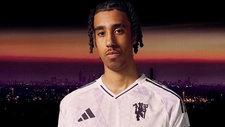 Leny Yoro modeling Manchester United's away shirt for the upcoming season.