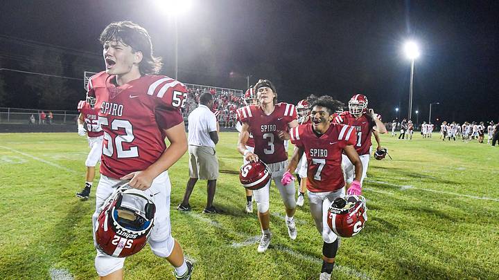 Spiro (Oklahoma) players Daniel Shepherd (52), Garon Dedmon (3), Connor Reed (7) and others celebrate following the Bulldogs' 12-6 overtime win against Panama on Aug. 31, 2023. Spiro (Oklahoma) players Daniel Shepherd (52), Garon Dedmon (3), Connor Reed (7) and others celebrate following the Bulldogs' 12-6 overtime win against Panama on Aug. 31, 2023.