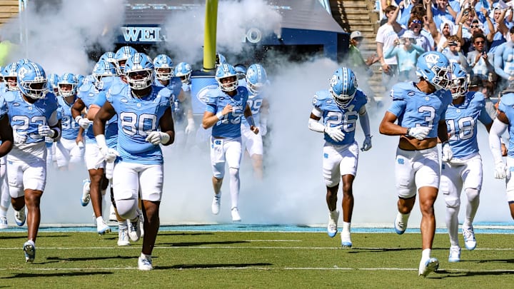 North Carolina running out on the field through smoke before its game against Clemson on Oct. 4, 2025. North Carolina running out on the field through smoke before its game against Clemson on Oct. 4, 2025.