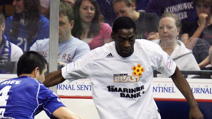 March 18, 2012; Milwaukee, WI, USA; Baltimore Blast forward Scott Buete (23) looks to pass the ball as Milwaukee Wave defender Josh Rife (4) defends during the first half at the U.S. Cellular Center.  Mandatory Credit: Mary Langenfeld-Imagn Images