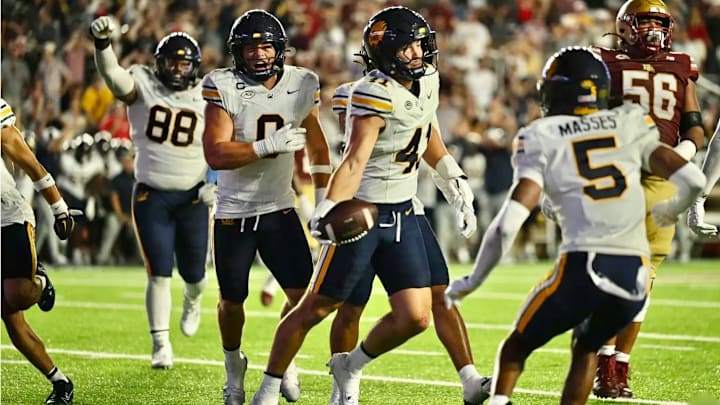 Luke Ferrelli (41) celebrates with teammates after his game-saving interception at Boston College Luke Ferrelli (41) celebrates with teammates after his game-saving interception at Boston College