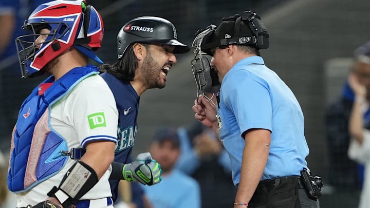 Oct 20, 2025; Toronto, Ontario, CAN; Seattle Mariners third baseman Eugenio Suarez (28) argues a called third strike with home plate umpire Quinn Wolcott in the eighth inning against the Toronto Blue Jays during game seven of the ALCS round for the 2025 MLB playoffs at Rogers Centre. Mandatory Credit: Nick Turchiaro-Imagn Images Oct 20, 2025; Toronto, Ontario, CAN; Seattle Mariners third baseman Eugenio Suarez (28) argues a called third strike with home plate umpire Quinn Wolcott in the eighth inning against the Toronto Blue Jays during game seven of the ALCS round for the 2025 MLB playoffs at Rogers Centre. Mandatory Credit: Nick Turchiaro-Imagn Images