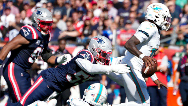 Patriots lineback Joshua Uche reaches out to bring down Miami quarterback Tyler Huntley in the first half. Patriots lineback Joshua Uche reaches out to bring down Miami quarterback Tyler Huntley in the first half.