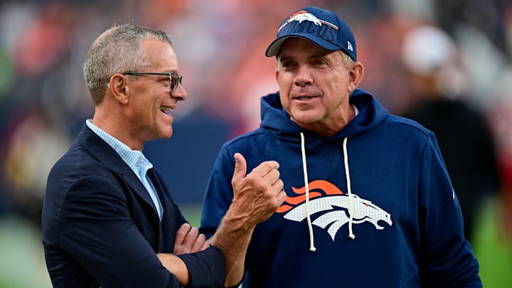 DENVER, CO - AUGUST 16: Denver Broncos head coach Sean Payton has a word with owner Greg Penner on the field before a preseason game between the Arizona Cardinals and the Denver Broncos at Empower Field at Mile High on August 16, 2025 in Denver, Colorado. 