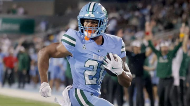 Tulane Green Wave running back Makhi Hughes (21) leaps into the end zone for a touchdown against the Southeastern Louisiana Lions during first half action at Yulman Stadium in New Orleans on Thursday, August 29, 2024.