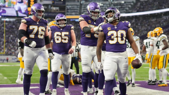 Jan 4, 2026; Minneapolis, Minnesota, USA; Minnesota Vikings offensive tackle Brian O'Neill (75) and Minnesota Vikings fullback C.J. Ham (30) celebrate after a touchdown against the Green Bay Packers during the second quarter at U.S. Bank Stadium. Mandatory Credit: Matt Blewett-Imagn Images