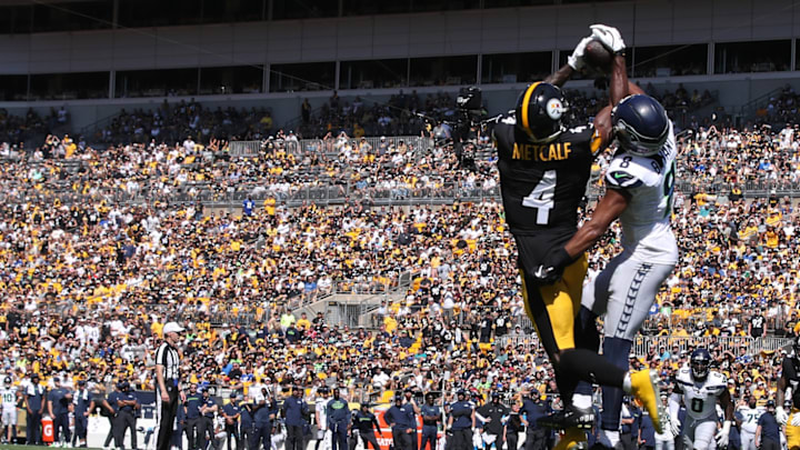 Sep 14, 2025; Pittsburgh, Pennsylvania, USA; Pittsburgh Steelers wide receiver DK Metcalf (4) catches a touchdown pass against Seattle Seahawks safety Coby Bryant (8) during the second quarter at Acrisure Stadium. 