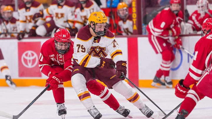 Gophers forward Mason Moe skating with the puck against Wisconsin.