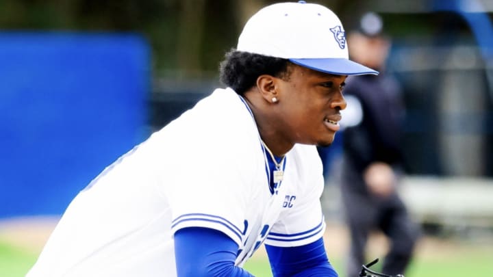 Left handed pitcher Robert Evans preparing for the the pitch.