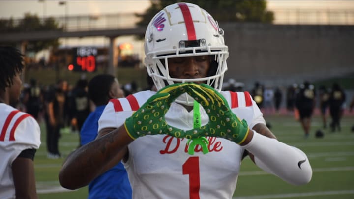 Dakorien Moore flashes Oregon Ducks gloves before his first game of his senior year at Duncanville High School. Dakorien Moore flashes Oregon Ducks gloves before his first game of his senior year at Duncanville High School.