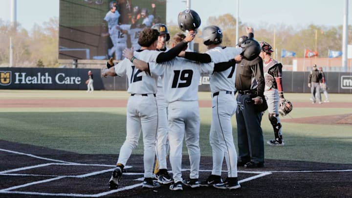 The Missouri Tigers Baseball team huddles together. 
