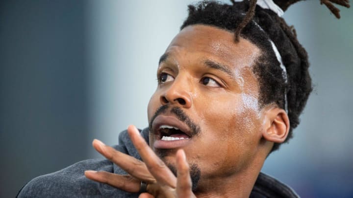 Former Auburn quarterback and NFL MVP Cam Newton runs a drill.