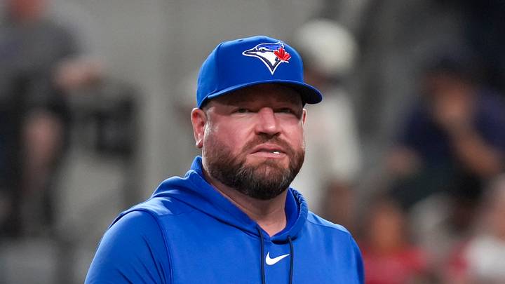 Sep 18, 2026; Arlington, Texas, USA;  Toronto Blue Jays manager John Schneider (14) walks to the dugout after a pitching change during the fifth inning against the Texas Rangers at Globe Life Field. Mandatory Credit: Raymond Carlin III-Imagn Images
