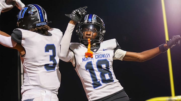 North Crowley's Kevin Moore (left) celebrates a TD with fellow senior wideout Jaidan Brooks in North Crowley's Week 4 win over Rockwall.