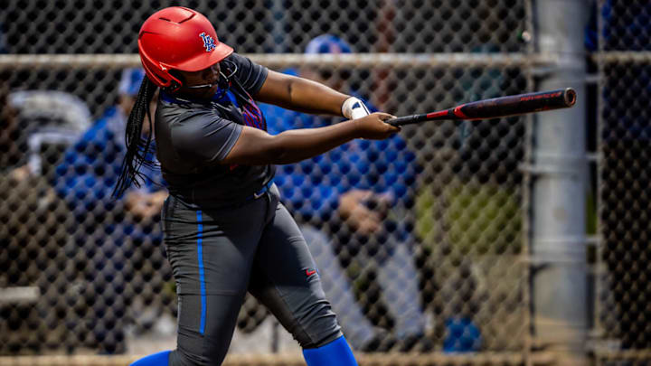 Los Alamitos softball player takes a swing against Huntington Beach.