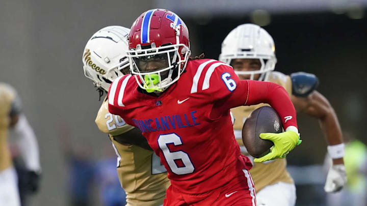 Duncanville's Trenton Yancey runs away from a defender in a game against Dallas South Oak Cliff earlier this year. 