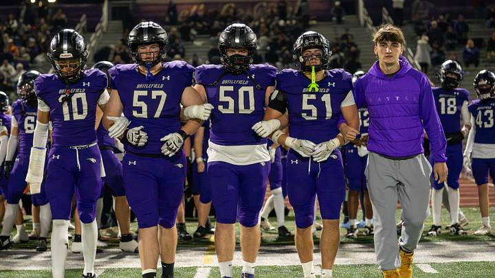 The Battlefield Bobcats lock arms for the coin toss. The Battlefield Bobcats lock arms for the coin toss.