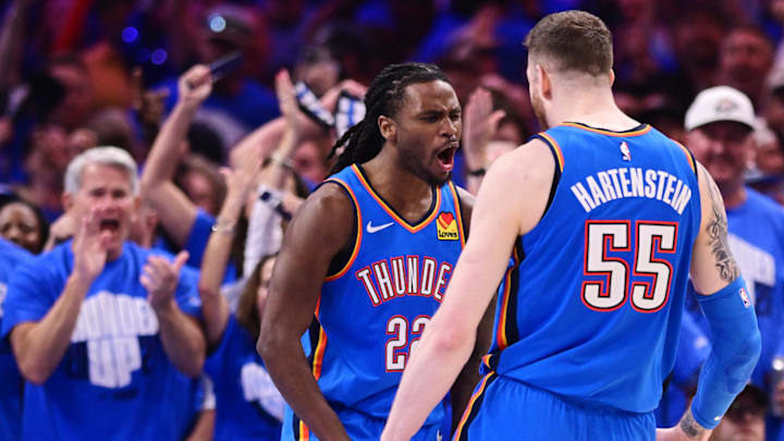 Oklahoma City Thunder players Cason Wallace and Isaiah Hartenstein celebrate after a play.