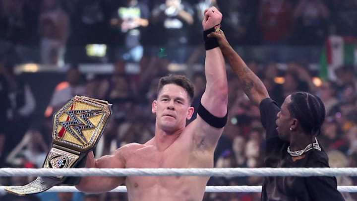 John Cena celebrates with Travis Scott after defeating Cody Rhodes for the Undisputed WWE Championship