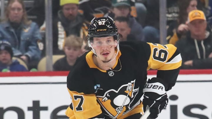 Mar 2, 2025; Pittsburgh, Pennsylvania, USA;  Pittsburgh Penguins right wing Rickard Rakell (67) skates with the puck against the Toronto Maple Leafs during the first period at PPG Paints Arena. Mandatory Credit: Charles LeClaire-Imagn Images