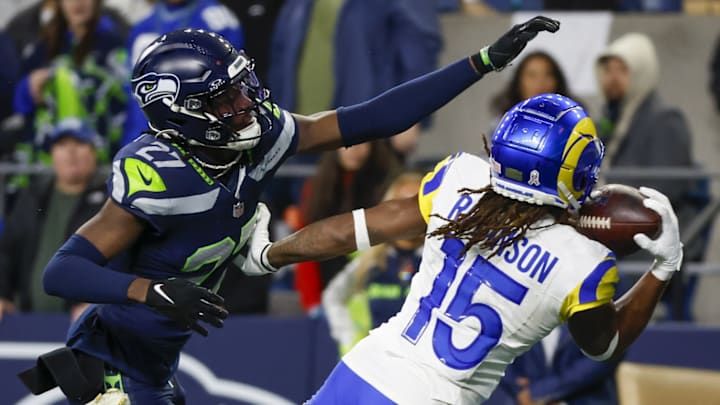 Nov 3, 2024; Seattle, Washington, USA; Los Angeles Rams wide receiver Demarcus Robinson (15) catches a game-winning touchdown pass against Seattle Seahawks cornerback Riq Woolen (27) during overtime at Lumen Field. 