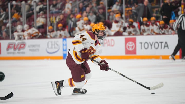 Gophers freshman Teddy Townsend skating with the puck against Michigan State.