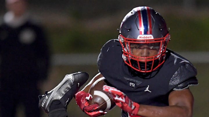Pike Road's Braylon Outlaw (5) scores a touchdown against Russell County's Cameron Vann (14) during their game in Pike Road, Ala., on Friday evening October 18, 2024. Pike Road's Braylon Outlaw (5) scores a touchdown against Russell County's Cameron Vann (14) during their game in Pike Road, Ala., on Friday evening October 18, 2024.