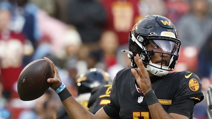 Washington Commanders quarterback Jayden Daniels passes the ball as Tennessee Titans linebacker Arden Key chases. Washington Commanders quarterback Jayden Daniels passes the ball as Tennessee Titans linebacker Arden Key chases.